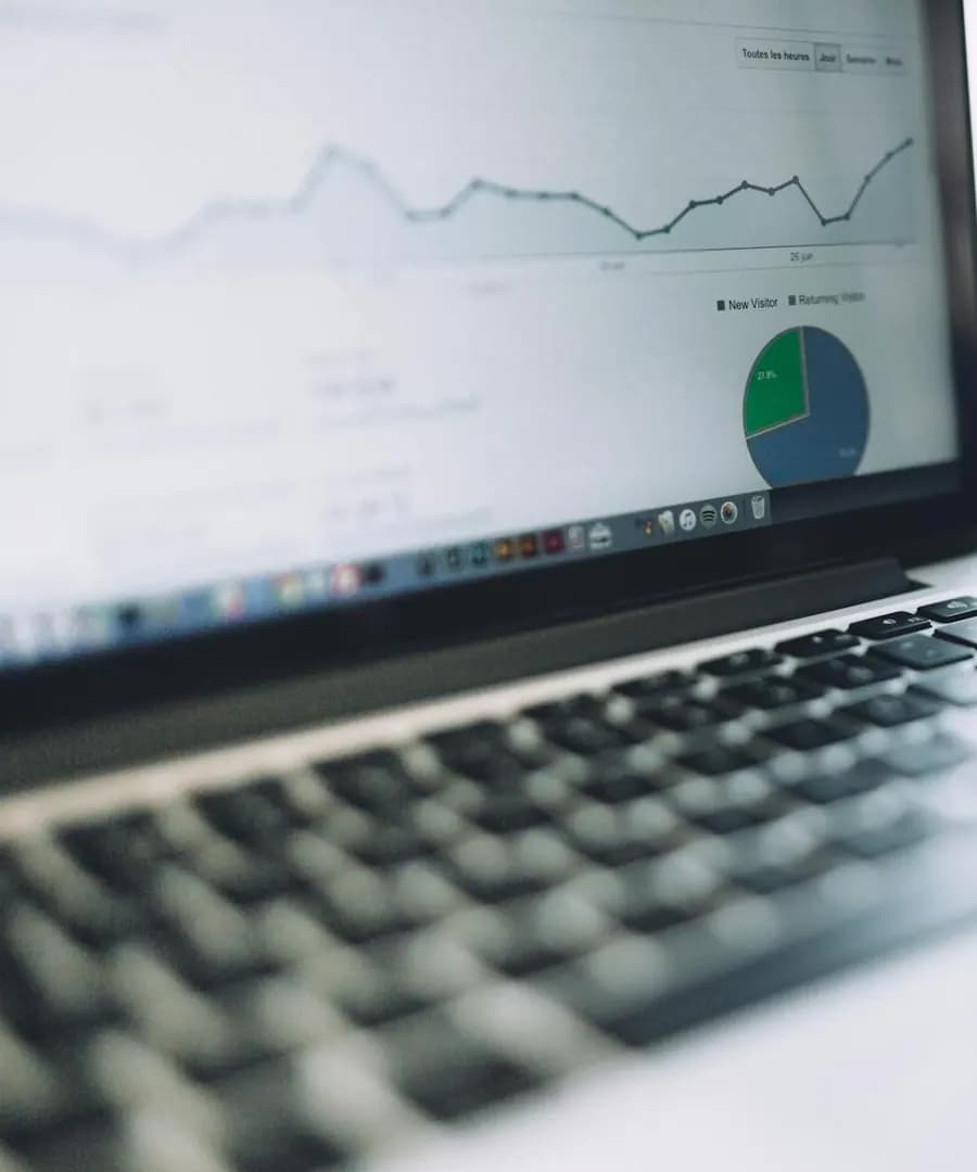 Laptop showing charts and marketing analytics for campaign reporting