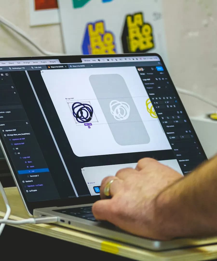 Designer working on a laptop screen with visual layout tools