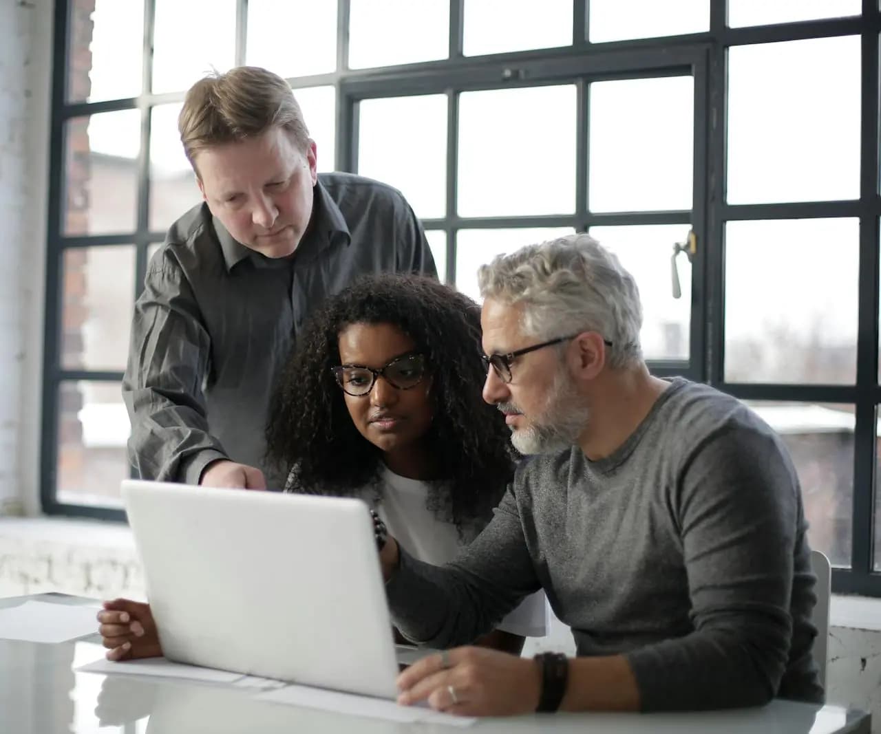Sales team reviewing a laptop workflow for lead qualification